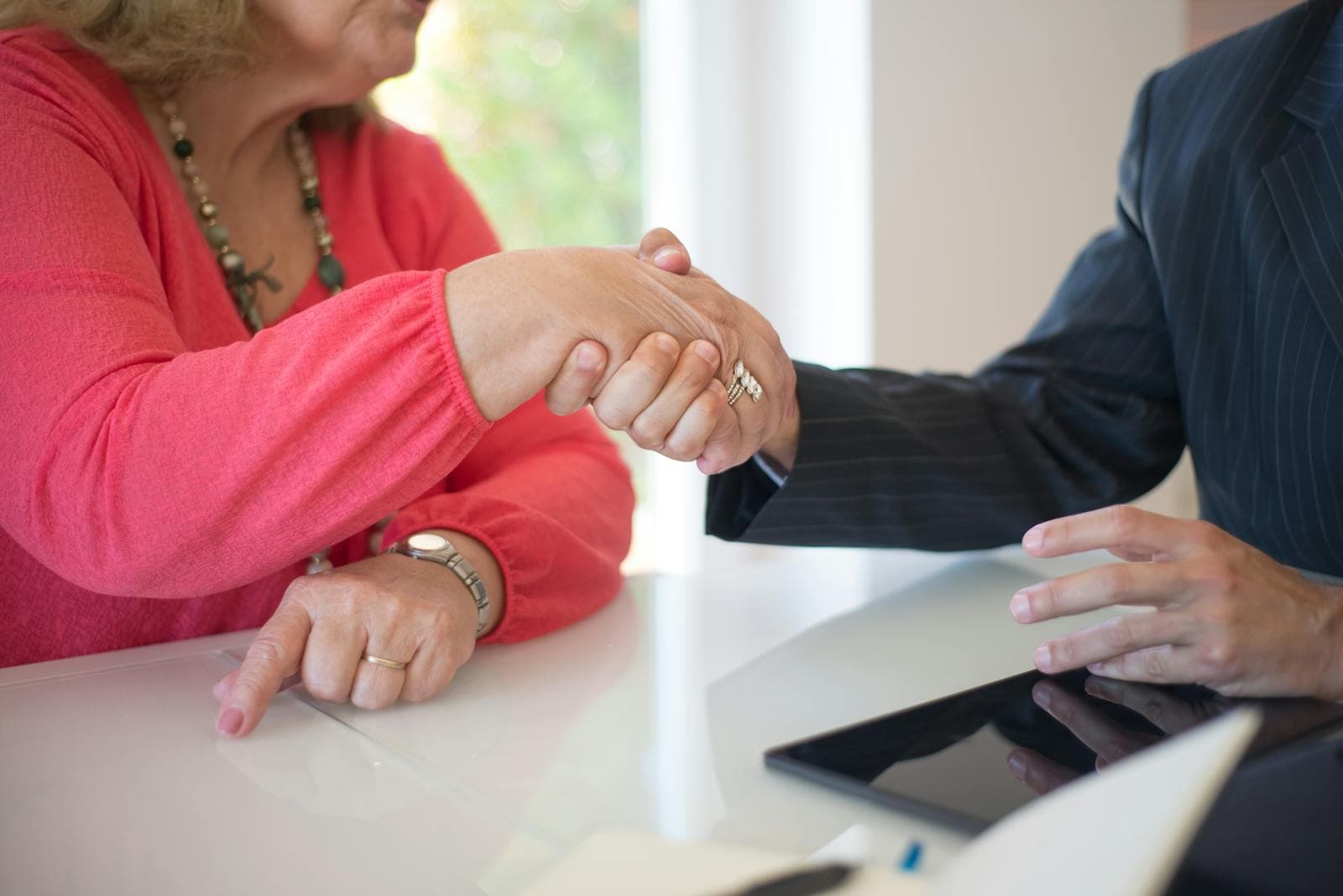 Close-up of a handshake symbolizing a fair, transparent senior care contract.